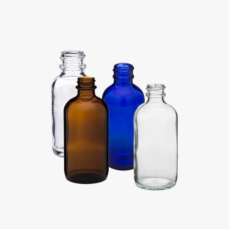 Clear, blue and amber glass Boston round bottles shown for color comparison